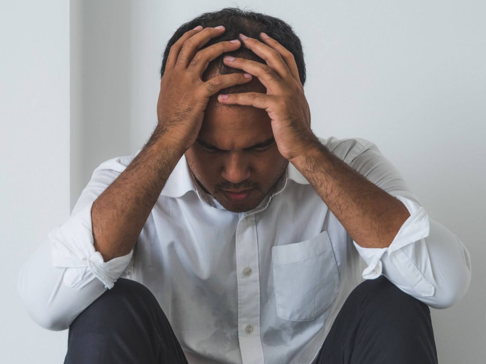 A man with his head in his hands